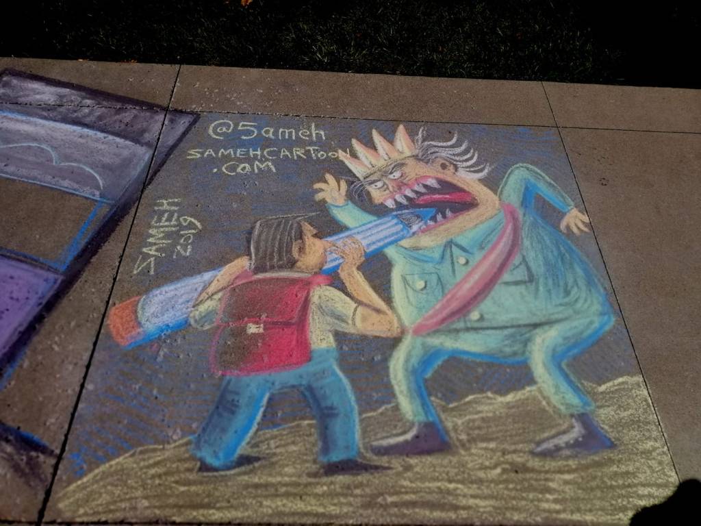 Chalk drawing of a mad king resembling Trump being confronted by an artist with a pen, inspired by St. George and the Dragon, created at a cartoonists' conference in Ohio.