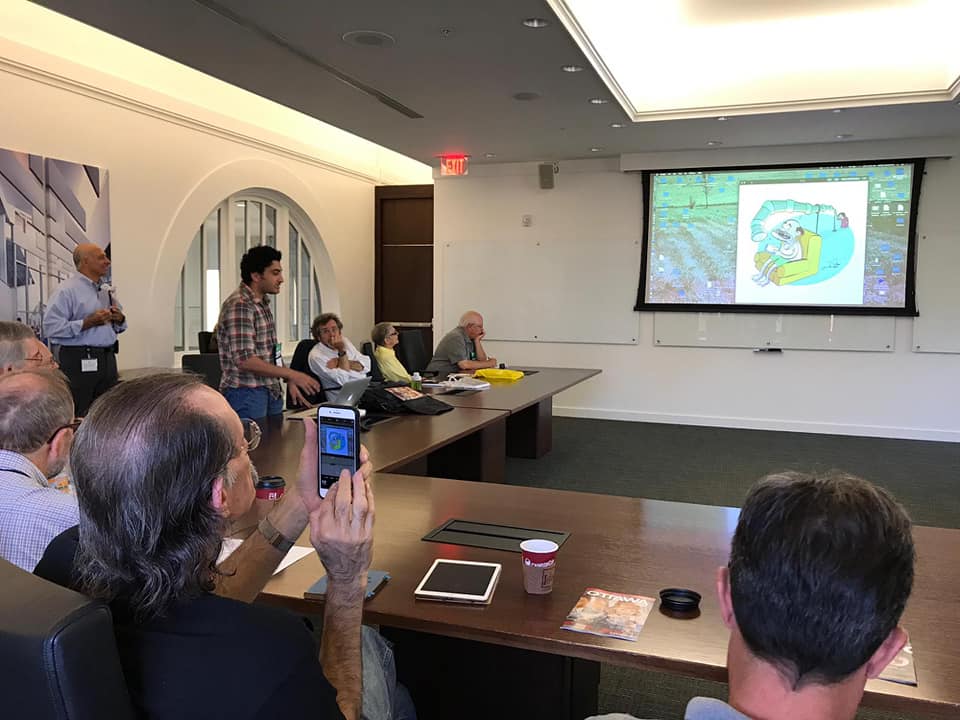 A meeting room with a cartoon projected on a screen showing a person relaxing in a hammock.