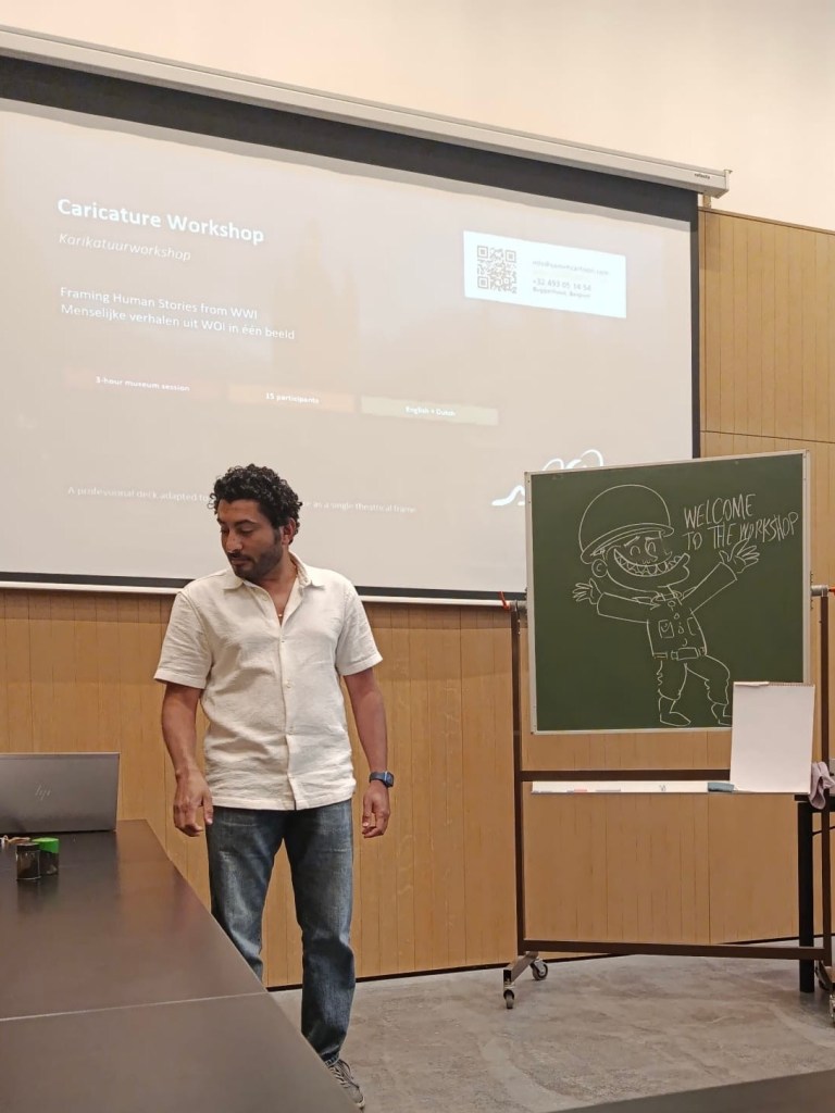 Sameh Samir conducts a political caricature workshop at the Ypres World War I Museum during Belgian Heritage Day, with participants observing a cartoon demonstration.