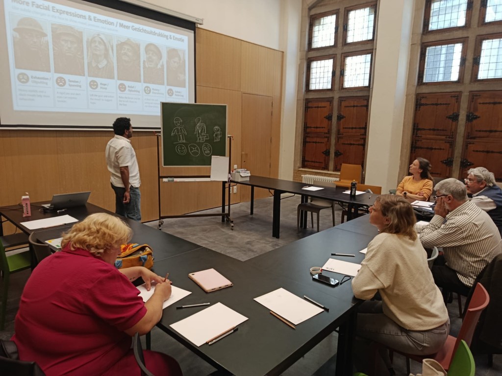 Sameh Samir conducting a political cartoon workshop at the Ypres World War I Museum during Belgian Heritage Day.