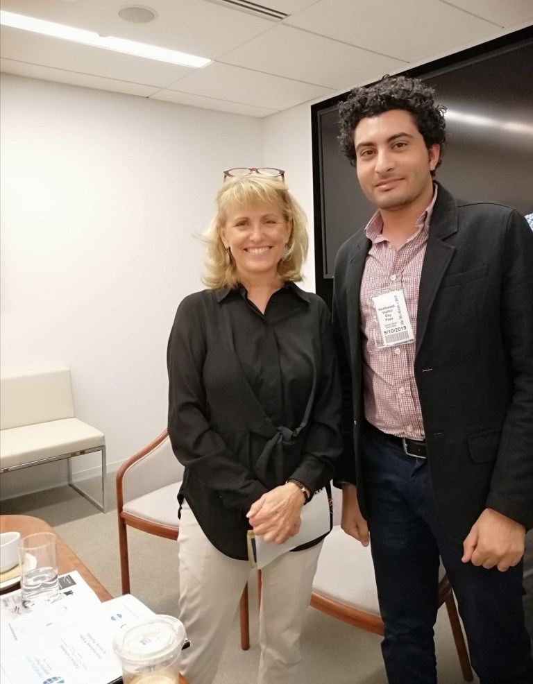 Sameh Samir and Ann Telnaes posing together in a modern office at The Washington Post.