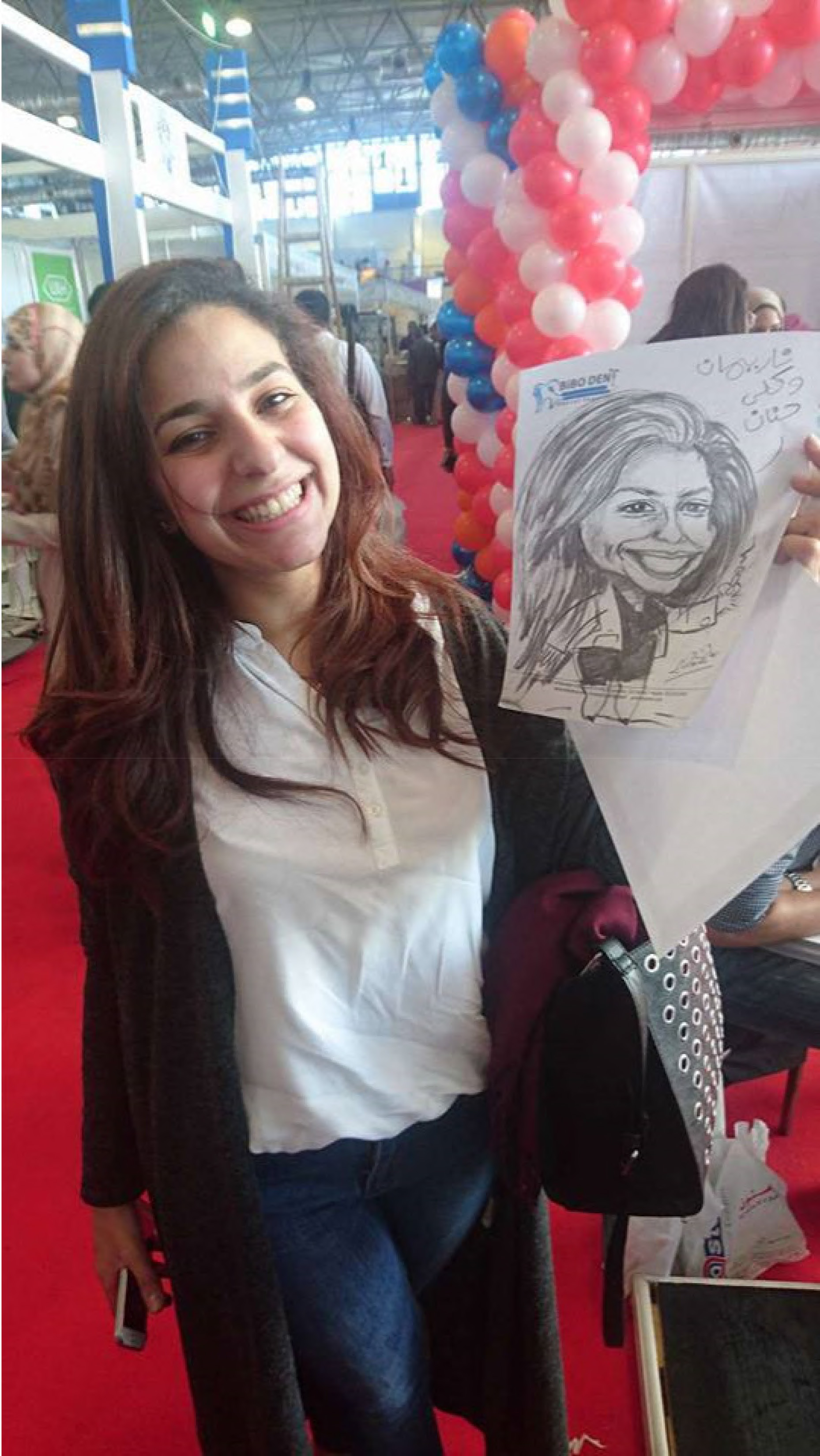 Woman holding live caricature drawing at a social event